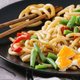 Plate of sesame udon noodles with chopsticks